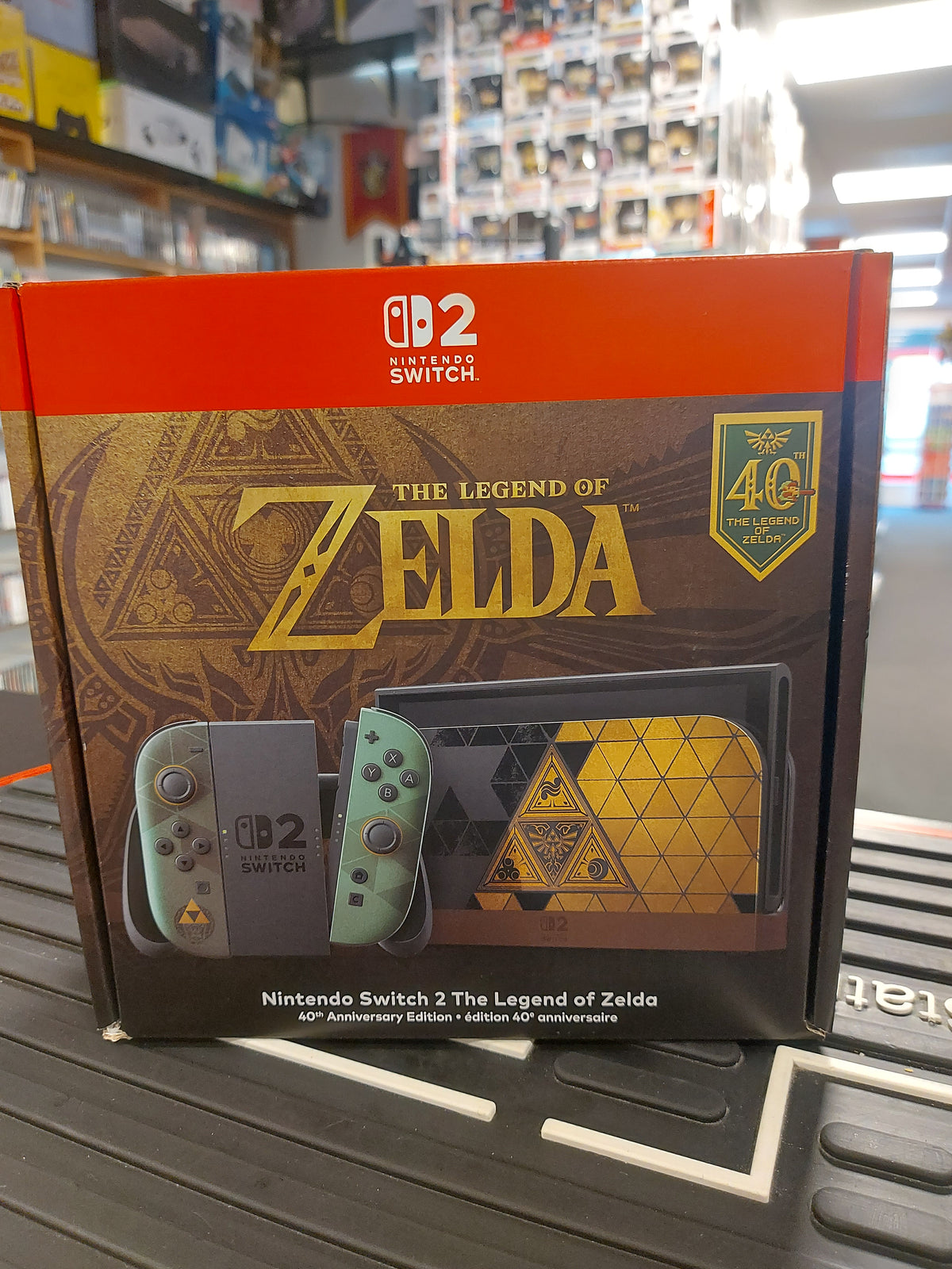 Nintendo Switch 2 Legend of Zelda Anniversary Edition box featuring Triforce design and Joy-Con controllers.