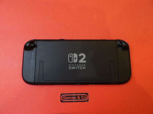 Used Nintendo Switch 2 console showing the back design on a red background.