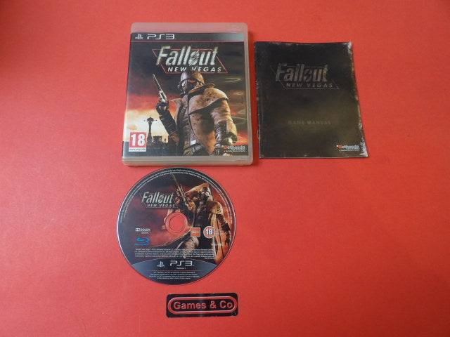 Fallout New Vegas Playstation 3 disc alongside game case and manual on a red background.