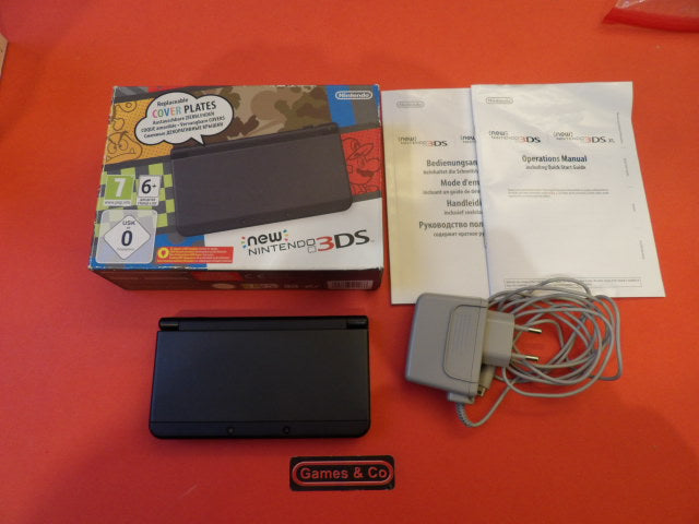 New Nintendo 3DS console with charger, box, manuals, and charger included in the image.