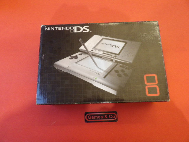 Nintendo DS console with charger in box, featuring the popular handheld gaming design.