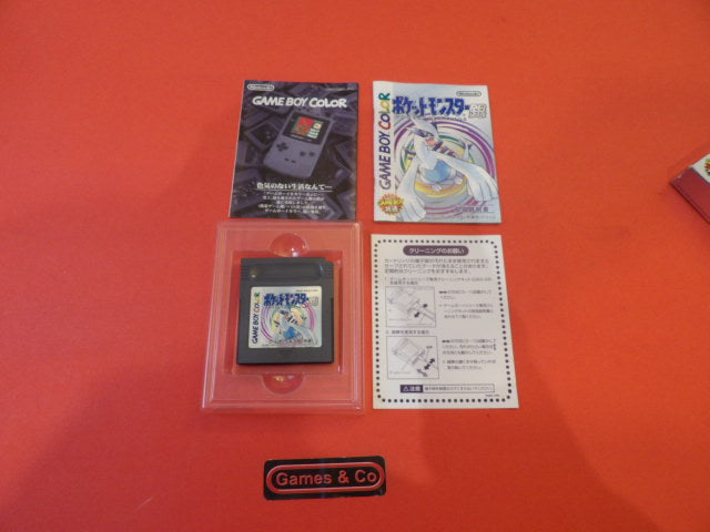 Pokemon Game Boy Color cartridge and manual displayed on an orange background.