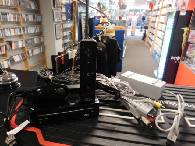 Used Wii console with GameCube compatibility, including controller, nunchuck, and all cables.