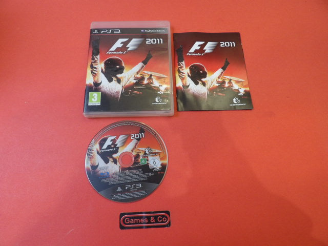 Formula 1 2011 Playstation 3 disc with case and manual on a red background.