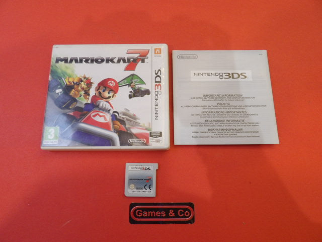 Mario Kart 7 Nintendo 3DS game box, cartridge, and manual displayed on a red background.
