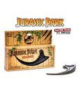 Jurassic Park Replica 1/1 Raptor Claw displayed on a wooden box with jungle theme.
